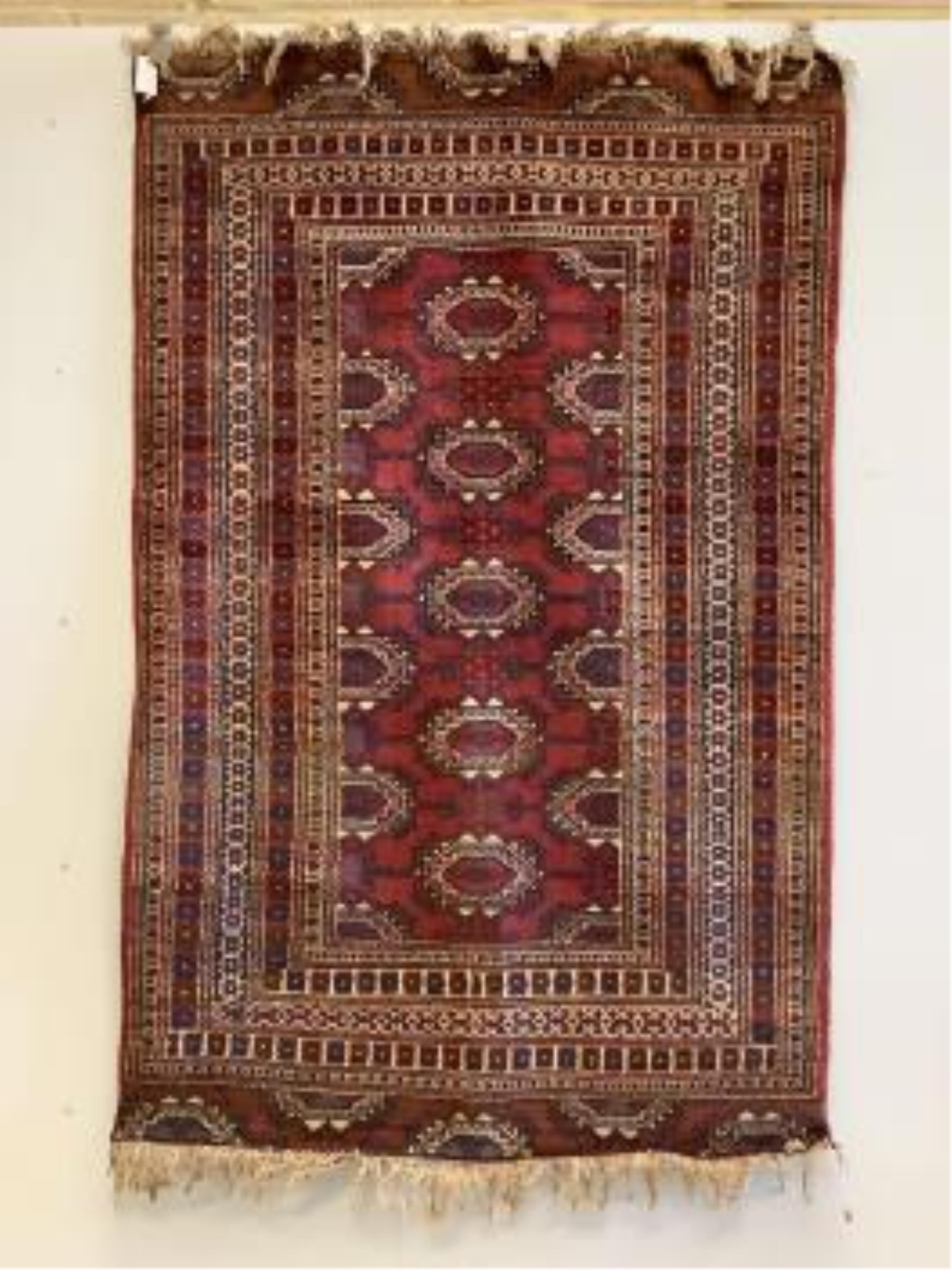 A Bokhara red ground rug, 191 x 124cm